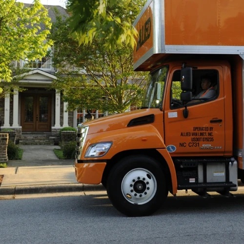 Allied moving van on street in front of house