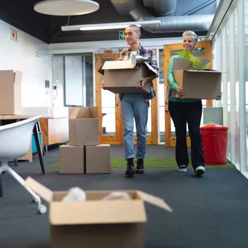 male-female-executives-carrying-cardboard-boxes-office-square